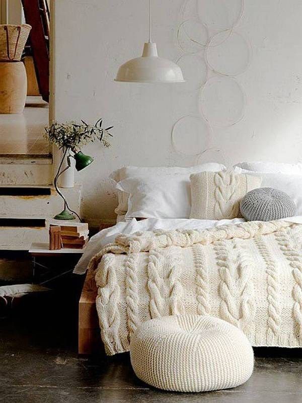 White knit bedding and pillows and an ottoman make the bedroom more winter like and very chic