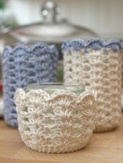 crocheted candleholder covers are a cute way to make them cozy and lovely and to save your furniture from heat at the same time