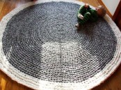 an oversized round crocheted rug is a beautiful idea for a kid’s room and it will make playing on the floor much cozier and safer