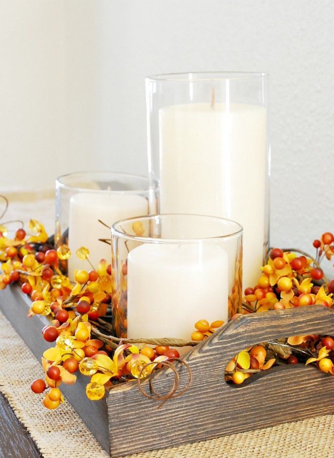 A wooden tray with berries and pillar candles is a very easy and very fall like arrangement to rock