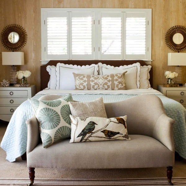 Neutrals, touches of green and blue and chocolate brown make the bedroom fall like yet rather calming and not bold