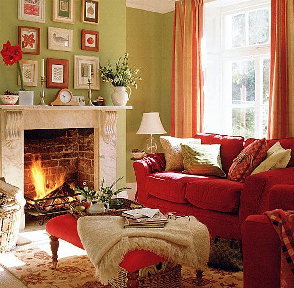 A bright red sofa, striped orange curtains and a fall inspired gallery wall make this living room fall like