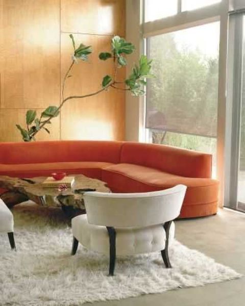 A curved orange sofa brings an autumn feeling to the space and makes it ultra modern at the same time