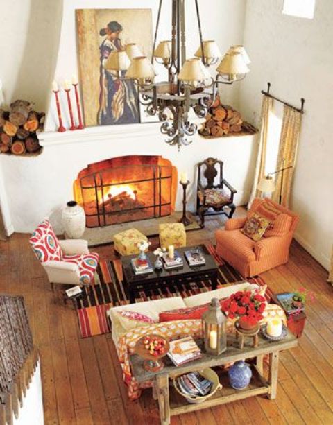 A bold printed rug, a rust colored chair and red textiles here and there make your space fall like