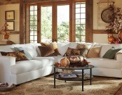 fall colored pillows and a rug add a fall feeling to the living room and make it seasonal easily