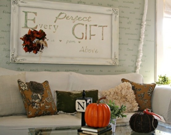 printed fall colored pillows and pumpkins add a fall touch to the living room