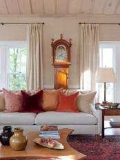 bright fall-colored pillows are enough to bring a fall feel to the living room