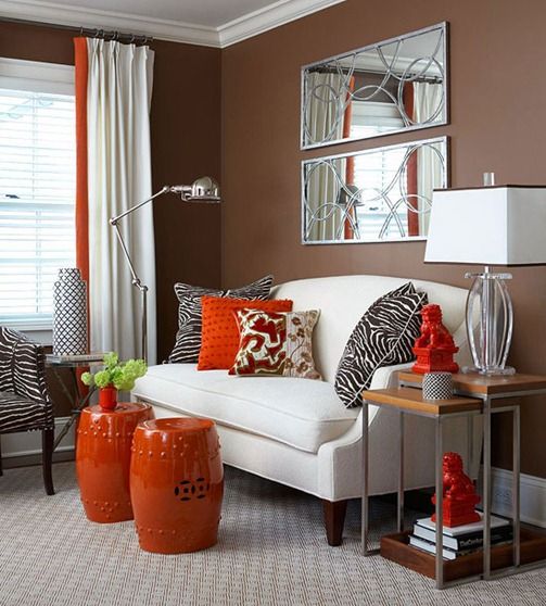 bright orange side tables, pillows and curtains will add fall flavor to the space decor