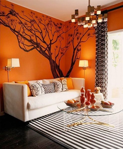 Statement orange walls and a tree for hinting that it's fall time   make a tree with decals to remove it when not needed