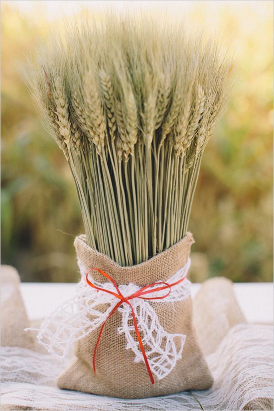 a wheat arrangement in a burlap sack with lace is a chic and simple decoration or a centerpiece for the fall