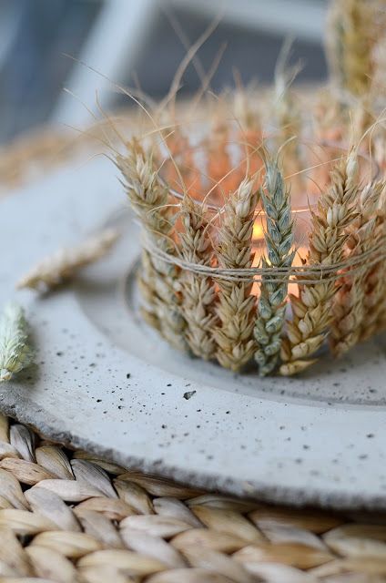 a candle holder of glass covered with wheat is a cool idea to make your table look like fall