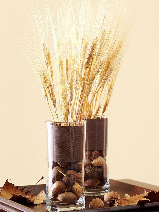 tall glasses with dried blooms and nuts, with chocolate brown fabric and wheat for a centerpiece or just decor