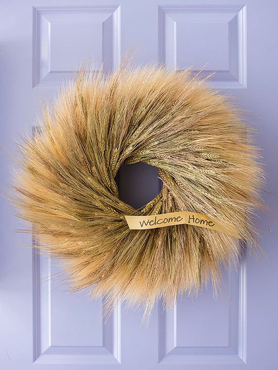A lush wheat wreath with a tiny tag is a fantastic and long lasting front door decoration for the fall