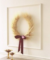 a wheat wreath with a purple ribbon bow for an accent and in a frame will make the space feel like fall