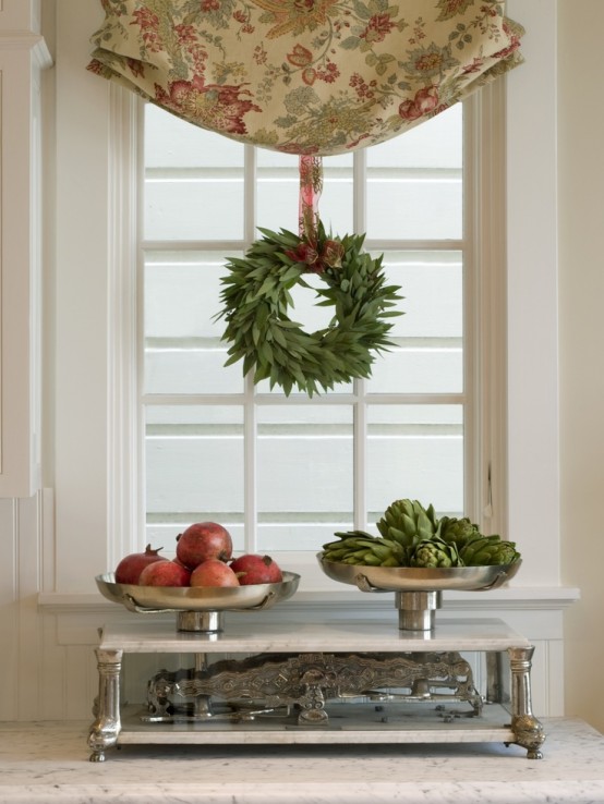 a greenery wreath hung to the curtain makes the space more holiday-like and cool