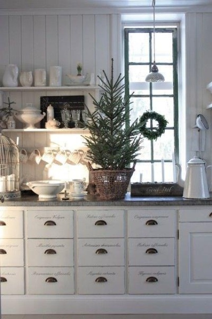 a mini Christmas tree and an evergreen wreath will easily bring a holiday feel to the space