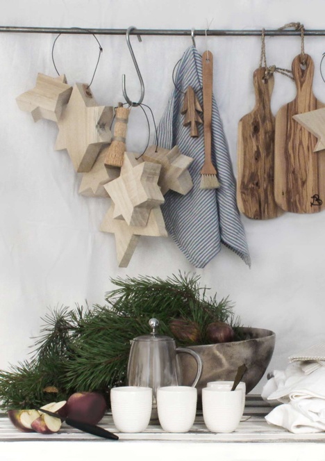 evergreens and pinecones, wooden stars and trees hanging on the holder for a Christmas feel in the kitchen