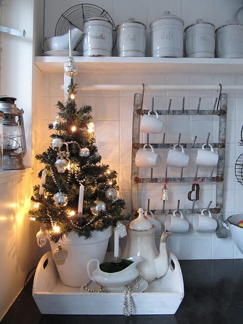 a mini Christmas tree with ornaments and lights will easily create a holiday ambienc in the kitchen