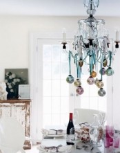a chandelier with pastel ornaments hanging down is a slight holiday touch to your kitchen