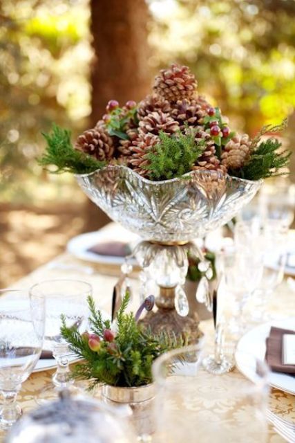 a crystal bowl and evergreens plus pinecones and berries for a vintage and rustic touch