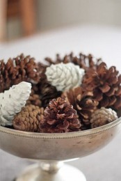 a stylish centerpiece of a vintage bowl filled with usual and whitewashed pinecones is easy to recreate