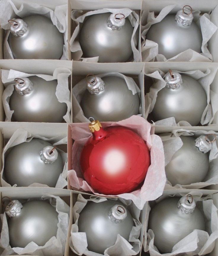 Silver grey Christmas ornaments and a single red one for lovely and chic Christmas decor   this color combo is timeless