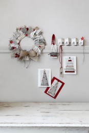 red and grey paper Christmas decor – a wreath, Christmas trees on paper and some pages with printing