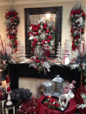 lush and refined Christmas decor with gorgeous evergreens, red and silver touches, grey lanterns, red berries and branches make up a very chic space