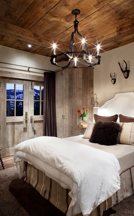 An old-school wrought iron channeller is a perfect light fixture for a rustic bedroom.