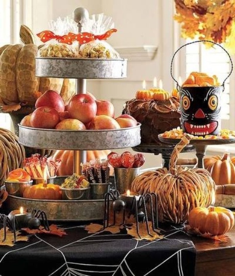 rustic dessert table styling with wooden and vine pumpkins, dried leaves, metal tiered stands for fruits and sweets