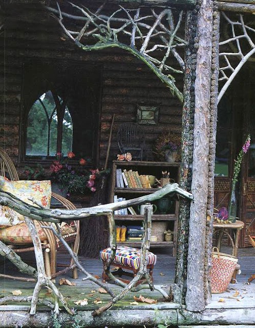 a rustic woodland patio with branch railings, wooden furniture, vintage furniture and potted blooms