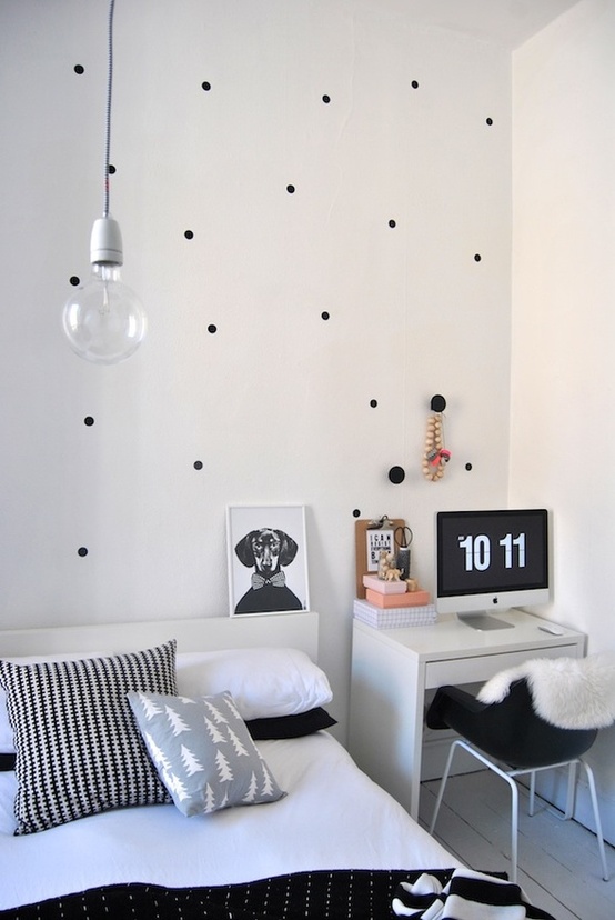 a monochromatic Nordic bedroom done with some prints, a bed, a deks space and a hanging bulb