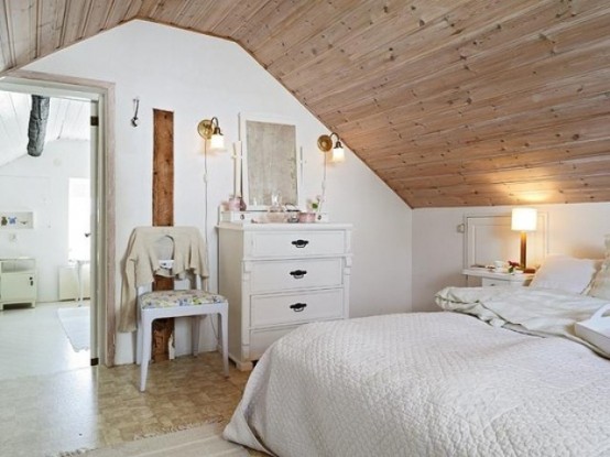 a chic Nordic space done in cremay shades, with neutral stained wood, vintage furniture and lamps and floral upholstery