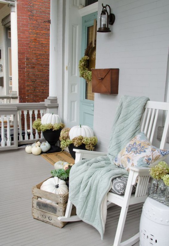 Pumpkins mixed with faux moss could become a great addition to your porch if you put them in planters. 