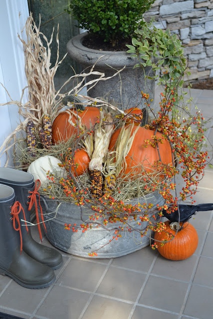 To spice up your outdoor Thanksgiving arrangement use not only pumpkins but indian corn too.