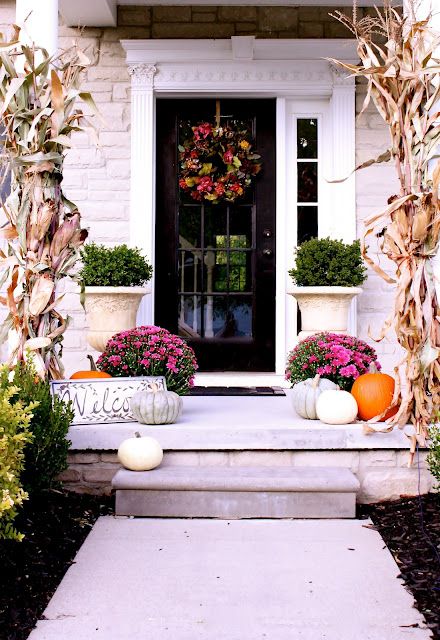 Welcome your family with a bunch of beautiful pumpkins in different colors and fresh fall blooms right on the front porch.