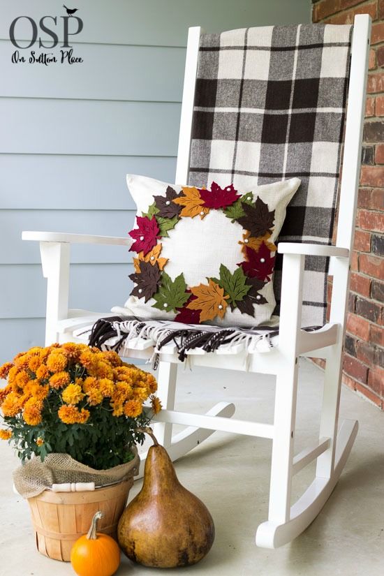 Give your porch or patio a warm touch by adding a cozy pillow. For example, a simple white pillow could be covered with DIY felt leaves in various colors.