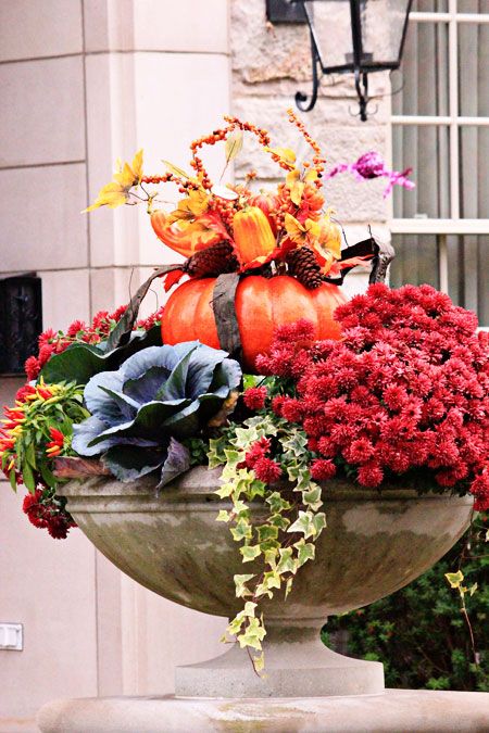 If the space allows put in your planters with fall blooms and other plants small pumpkin centrepieces. This is an easy yet great idea for a seasonal upgrade.