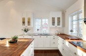 a white kitchen warmed up warm stained butcherblock countertops and add color to the space