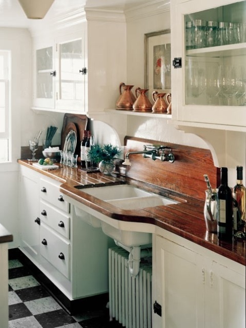 a vintage white kitchen made catchy and interesting with dark wooden countertops looks more dramatic and bold