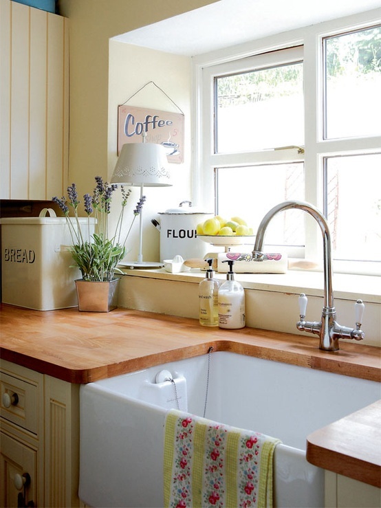 A cozy farmhouse style kitchen design with a wooden countertop