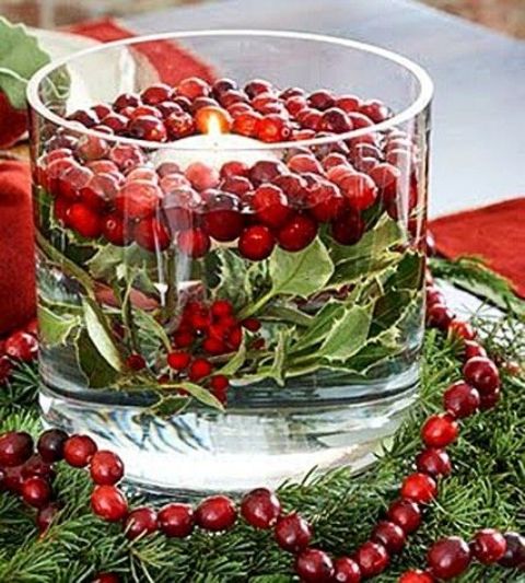 a large jar with greenery and berries plus floating candles is a fantastic decor idea for Christmas, an easy and fast craft