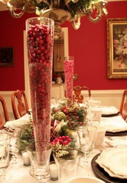 Tall cone shaped glasses filled with cranberries will instantly give your festive table a Christmassy look and feel, whatever decor they are paired with
