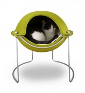 a  neon pod on metal legs is not just a bed, it’s a retreat to hide inside, it’s bright and cool