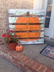 a fall pumpkin sign, a potted flower and a Jack-o-lantern for decorating your front porch
