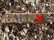 a simple rustic fall sign with a bright red leaf painted on it brings a relaxed feel to any space