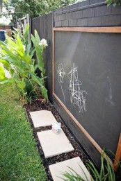 a large chalkboard and colorful chalk will inspire your kids’ creativity outdoors, too