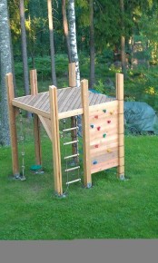 a small kids’ play space of wood, with a climbing wall and a ladder is easy to build