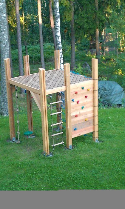 a small kids' play space of wood, with a climbing wall and a ladder is easy to build