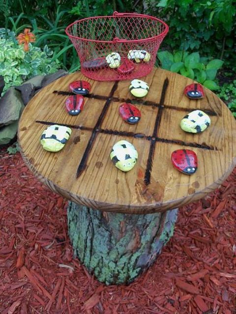 A small tic tac toe table with colorful stones is absolutely DIYable and you can make all its parts yourself